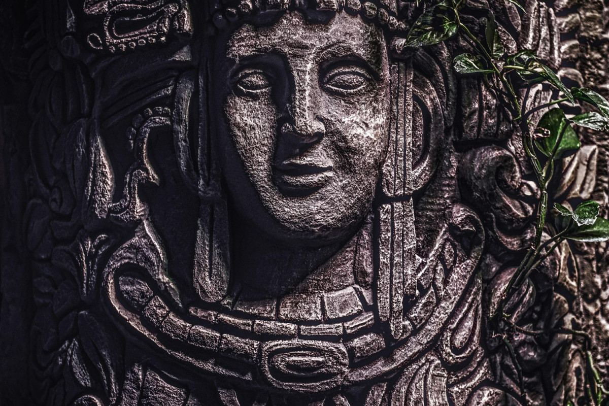 Beautiful rocky monument with carved image of human face in the jungle close up view