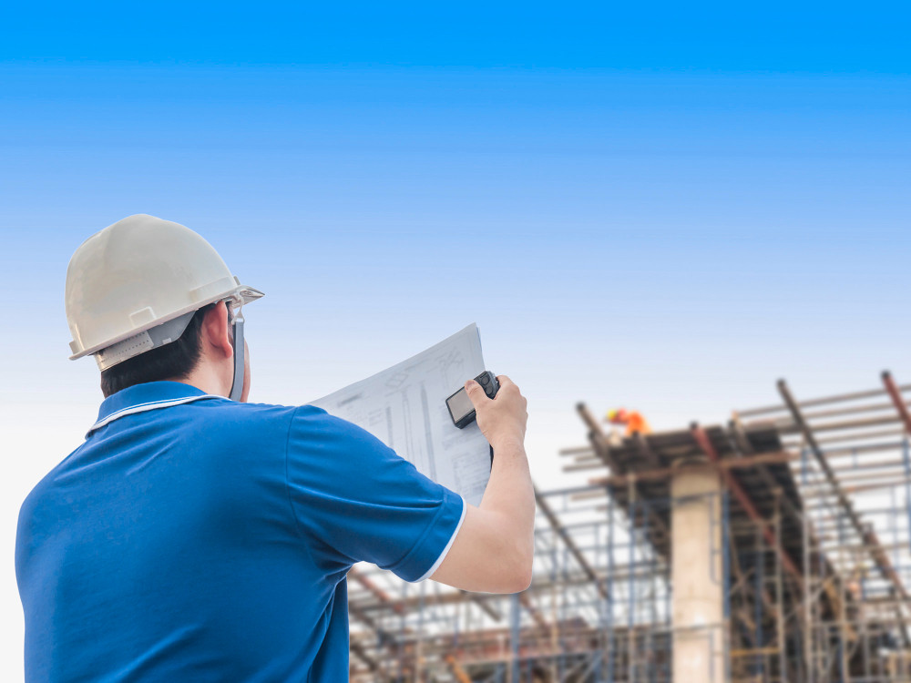 Engineer is inspecting his work in building construction site